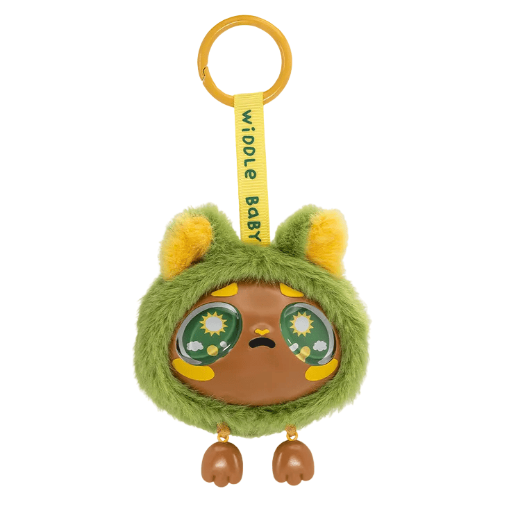 A round, brown keychain toy from Kaleidos Creative’s Widdle Baby Big World Bag Clip Blind Box features big, sad eyes, green and yellow fluffy fur, small ears, and two little brown feet that dangle below. It comes with a yellow keyring and a ribbon labeled “widdle baby,” making this adorable accessory the perfect addition to any bag.