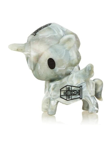 The tokidoki Unicorno After Dark S5 Little Zombie Limited Edition features a small, marble-like unicorn with black eyes and a black door design on its side, displayed on a white background.