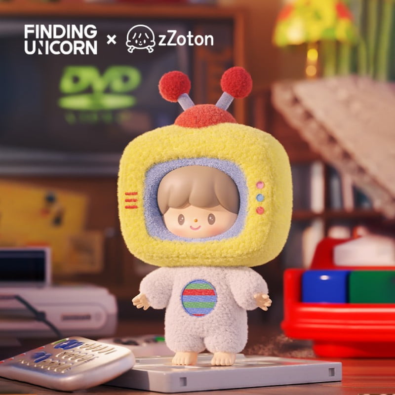The zZoton — Happy Childhood Blind Box by Finding Unicorn features a cute collectible figure with a TV-shaped yellow head, antennae, and grey outfit—ideal nostalgic gift for fans. “Finding Unicorn x zZoton” appears in the top left of the packaging.