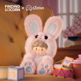 ZZoton — Happy Childhood Blind Box from Finding Unicorn features a doll in a fluffy pink bunny costume with big ears and paw prints, sitting on a yellow chair among colorful blocks and drums—ideal for collectible figure fans or as a nostalgic gift.