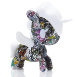 A small toy unicorn with tokidoki's Manga Mania Unicorno Blind Box comics on it.