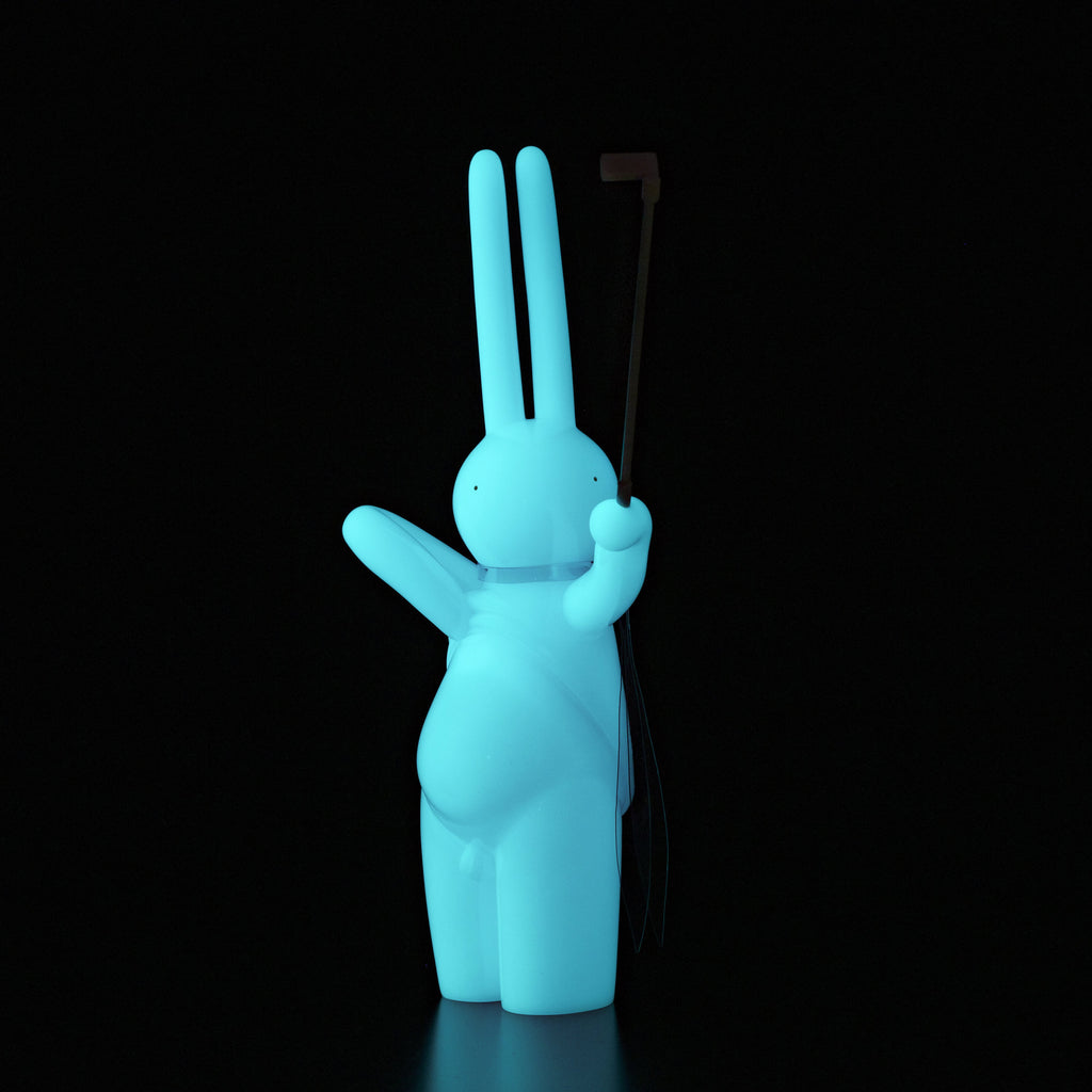 A blue bunny holding a golf club on a black background, created by Japanese vinyl artist mr. clement for The Daily Flasher by Tomenosuke Shoten (JP).