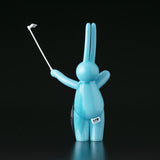 A blue bunny figurine, also known as The Daily Flasher by mr. clement, holding a golf club.