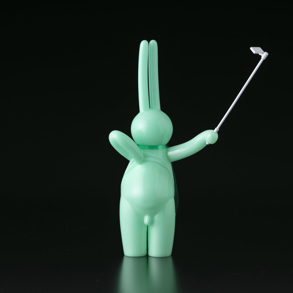 A green bunny figurine holding a golf club, designed by Mr. Clement in Japanese vinyl from Tomenosuke Shoten (JP), called The Daily Flasher by mr. clement.