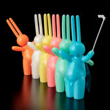 A row of colorful The Daily Flasher bunny figurines, inspired by Japanese vinyl toys by Tomenosuke Shoten.