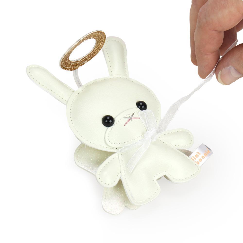 A person is holding a white bunny toy, a Holiday 5