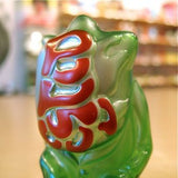 A Popsoda Finger Puppet - Clear Green with red and white writing on it perfect for a puppet show or kaiju enthusiasts.