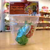 A Popsoda Finger Puppet - Clear Green in a plastic bag on a table, perfect for a puppet show with finger puppets.