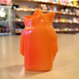 A small Popsoda Finger Puppet - Orange sitting on a table.