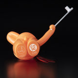 An orange toy with a knife on it, created by Mr. Clement from Japanese vinyl - The Daily Flasher by Mr. Clement from Tomenosuke Shoten (JP).