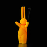A yellow bunny holding The Daily Flasher against a black background, designed by mr. clement for Tomenosuke Shoten.