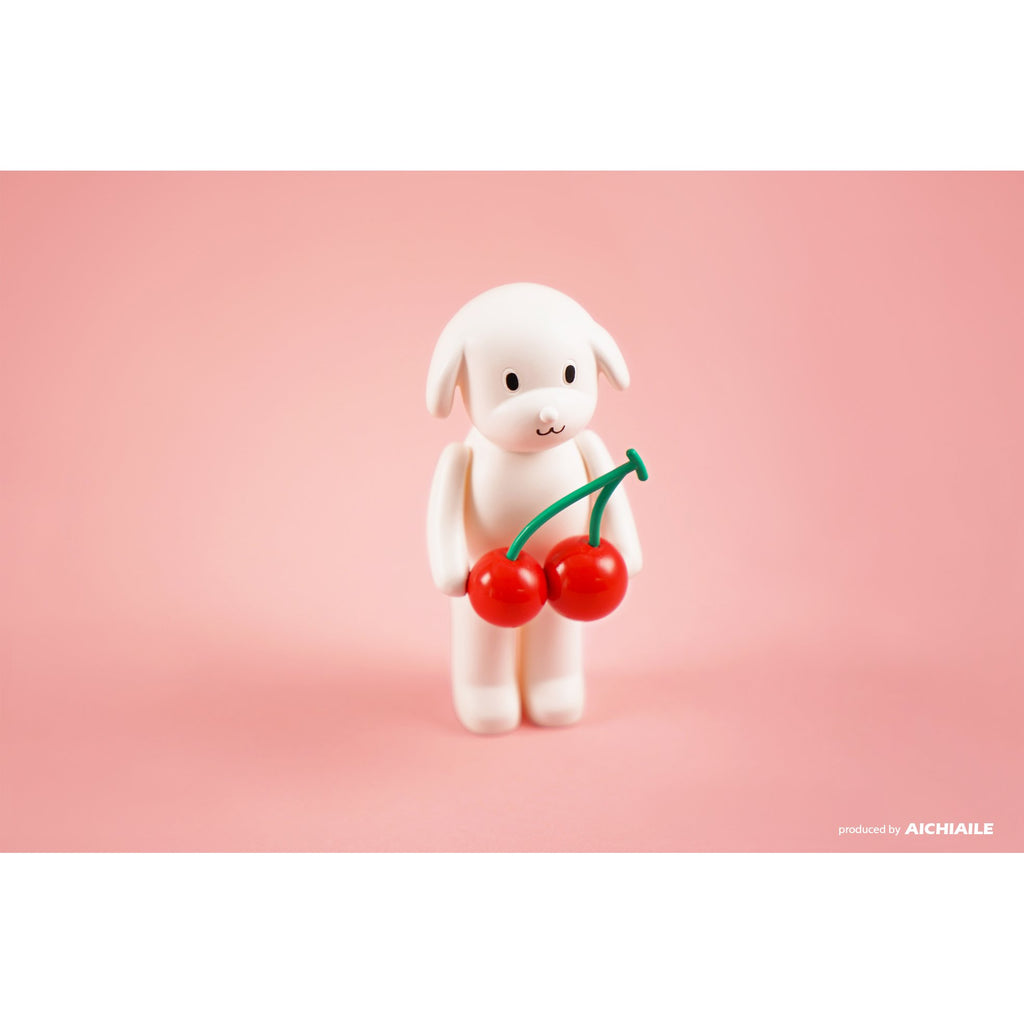 A limited edition Puppy Tang F2 — I Like Big Cherry resin figure holding a cherry on a pink background by AICHIAILE.