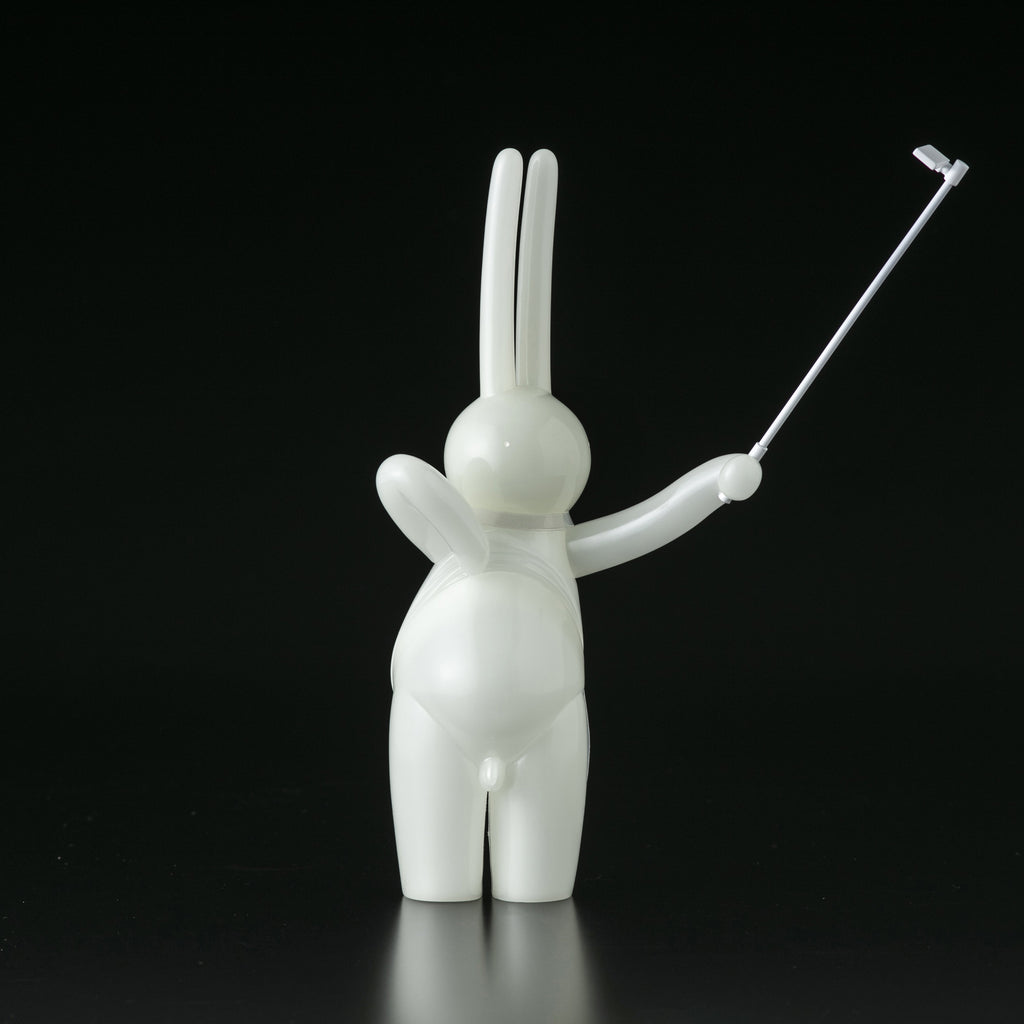 A white figurine of a rabbit holding a golf club, made from Japanese vinyl by Tomenosuke Shoten (JP) featuring The Daily Flasher by mr. clement.