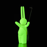 A green bunny holding a golf club on a black background by Tomenosuke Shoten (JP) featuring The Daily Flasher by mr. clement.
