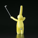 A yellow bunny holding a golf club on a black background by Tomenosuke Shoten (JP), The Daily Flasher.