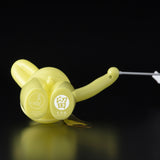 A yellow Japanese vinyl toy with an arrow sticking out of it, The Daily Flasher by Tomenosuke Shoten.