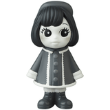 A black and white figurine of a girl wearing a coat, inspired by Japanese vinyl toy artists, the VAG 31 β Uramy and Tsurami by Medicom (JP).