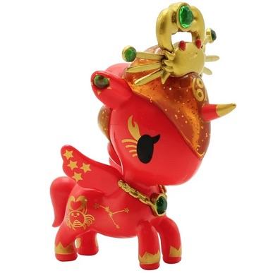 A red toy with a gold crown on it, inspired by tokidoki's Zodiac Unicorno — Cancer.
