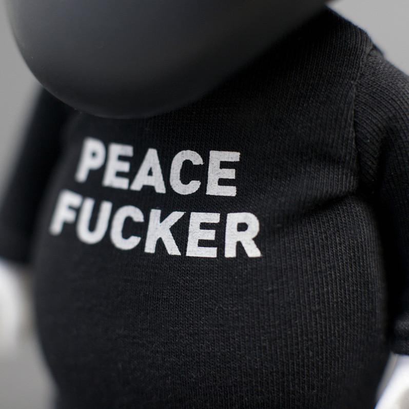 Close-up of a Playge (HK/US) Squadt GERM s006 black shirt with the provocative phrase 