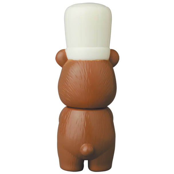 A brown bear wearing a white hat on its head, inspired by Japanese vinyl toy designs, like the VAG Series 28 β Koguma Kekiyasan by Kamentotsu from Medicom (JP).