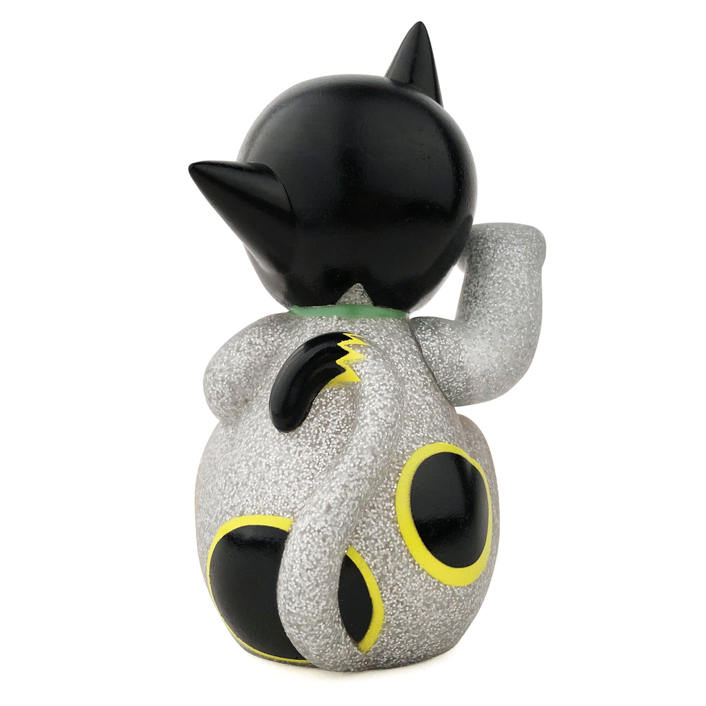 A Maneki-Astro figurine of a cat with black spots by DoomCo Designs (US).