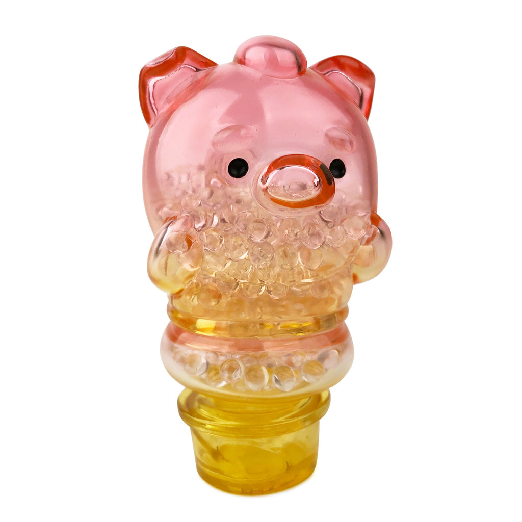 A pink pig shaped glass bottle with a lid resembling Sun Day Toy's Meng Meng Bing — Pig Popsicle Mini-Figure.