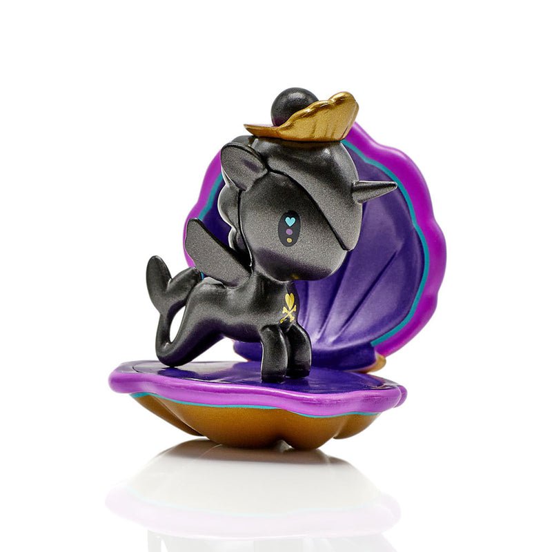 A little black pony figurine from the tokidoki Mermicorno Series 7 Blind Box sitting on top of a shell.