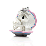 A figurine of a unicorn sitting on top of a shell from the Mermicorno Series 7 Blind Box by tokidoki.