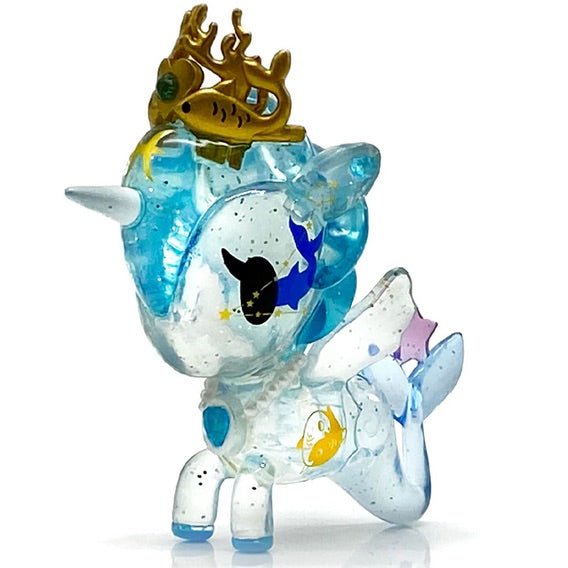 A compassionate tokidoki Pisces Zodiac Unicorno figurine with a crown on its head.