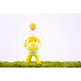 A yellow Little Forest Pre-Order Puppy Tang toy puppy is standing in the grass.