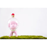 A pink Puppy Tang from the Little Forest series with a house on top of grass.