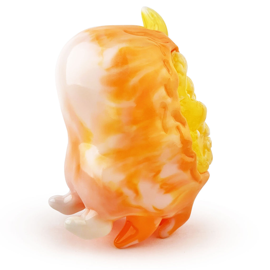 An orange and white Candy Corn toy on a white background by Squibbles Ink (US).