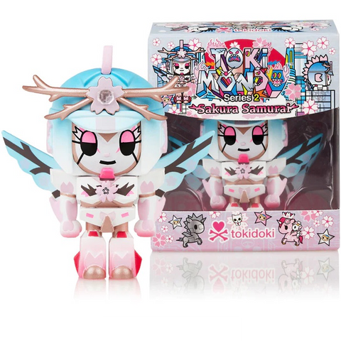 A tokidoki limited edition Tokimondo Series 2 Sakura Samurai figure in a pink and blue outfit stands in front of a box.