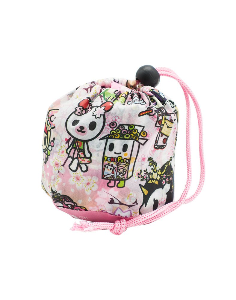 A pink drawstring bag with a kawaii Tokidoki Hanami Picnic Reusable Tote character on it.