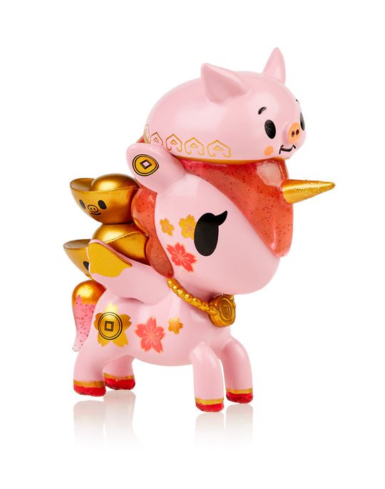 A Lunar Calendar Metallico Blind Box Unicorno figurine with a pig on its head by tokidoki.