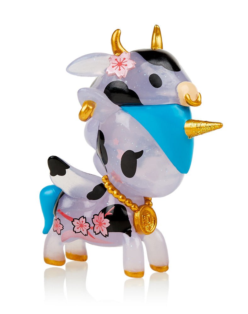 A Unicorno — Lunar Calendar Metallico Blind Box figurine of a cow with horns and flowers by tokidoki.