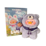 A Toyzero+ Lulu the Piggy — Joyful Time Plush Blind Box features a plush pig in a purple bear costume, standing before its colorful box with whimsical pig designs—adorable as a cute keychain accessory.