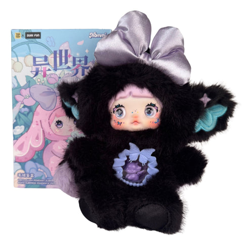 A Nommi Fantasy World Plush Blind Box doll in a black faux-fur hooded animal suit, featuring a lavender bow and a clear chest pendant, displayed in front of its illustrated product box.