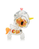 The Tokidoki Sugar Shop Unicorno Blind Box offers a transparent unicorn figurine with vibrant orange and yellow decorations, a playful pink heart on its head, and an orange tail, embodying sweet charm like discovering a hidden treasure.