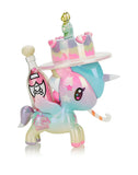 The Tokidoki 20 Candles Unicorno Special Edition toy celebrates Tokidoki's Twentieth Anniversary with a cake-shaped party hat and pastel shades of blue, pink, and purple, complete with whimsical star patterns.