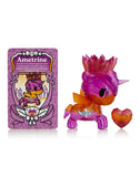 A Tokidoki Precious Unicorno Blind Box contains a pink and orange toy figure with a matching heart accessory, accompanied by a 