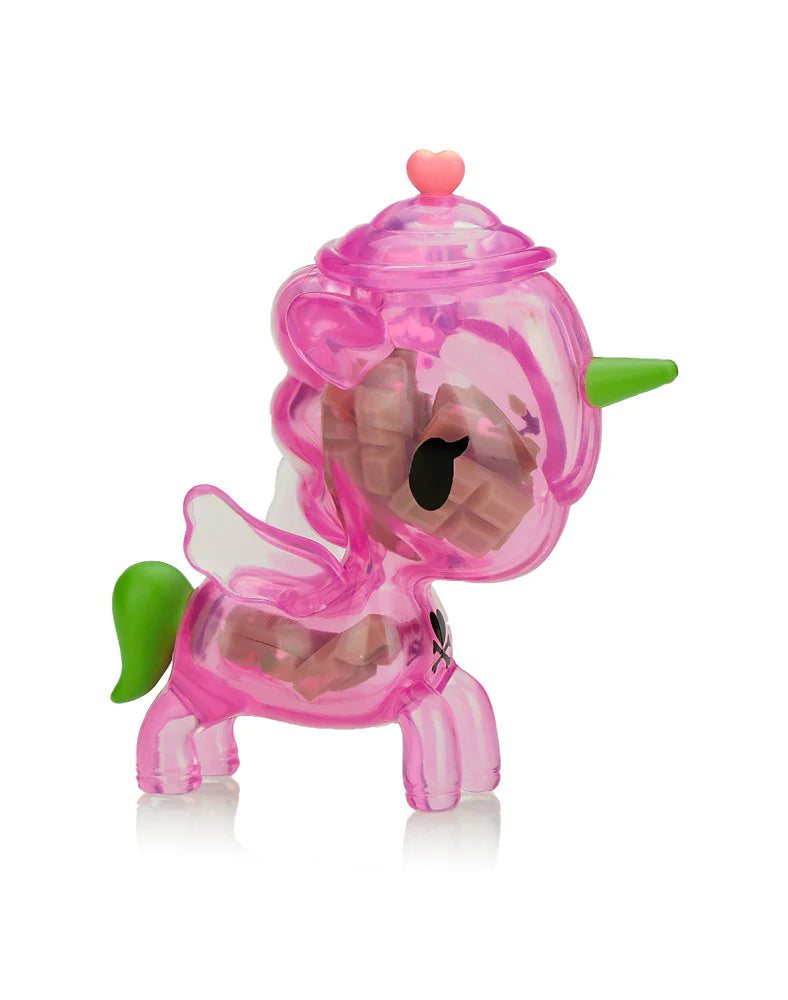 This enchanting Tokidoki Sugar Shop Unicorno figurine, featuring pink translucence, a green horn and tail, plus wings and a heart on its head, is a sweet surprise in each blind box—uncover the magic with every purchase!.