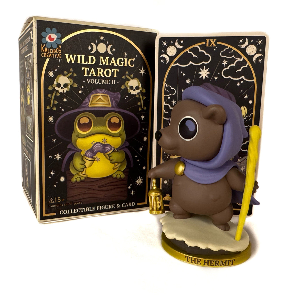 A bear figurine wizard holding a lantern and staff stands on a 