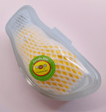 The Banana Boo - Yellow by Rotofugi is packaged in white foam and a clear plastic container with a green 
