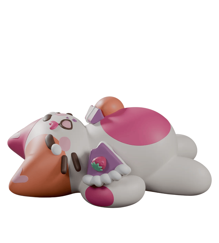 A cartoonish, chubby cat figurine with pink and orange markings lounges with a purple book featuring a strawberry—part of Kaleidos Creative’s adorable “Bake Me A Cat Blind Box” collection.