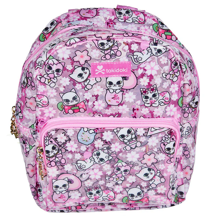 The Tokidoki Cherry Blossom Cats Clear Backpack features cartoon cats, flowers, hearts, a front zip pocket, and gold zipper pulls.