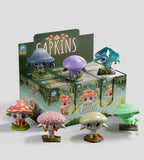 Seven vibrant mushroom-shaped Capkins figurines from Kaleidos Creative's Fungi Forest are displayed before a Capkins Series 1 Blind Box, which features six compartments and playful woodland-themed packaging.