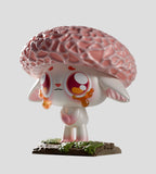 A Capkins Series 1 Blind Box vinyl figure by Kaleidos Creative, featuring a sad creature with large pink eyes, orange tears, and a textured pink mushroom cap, standing on a grassy base.