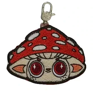 The Capkins Mystery Coin Bag by Kaleidos Creative is a collectible keychain with an embroidered cartoon face and a red, white-spotted mushroom cap—perfect for fans of blind box surprises and Capkins coin purses!.