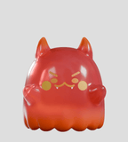 The Cute as Heck! Blind Box by Kaleidos Creative features a red, glossy Heckites cat-like figure with pointed ears, small fangs, yellow facial markings, and rounded arms—perfect for collectible fans and blind box lovers.